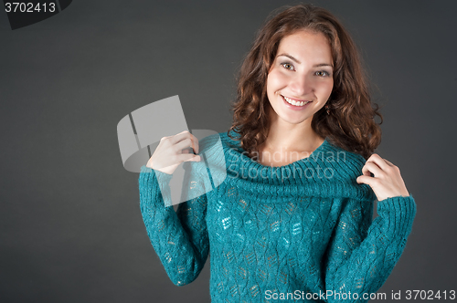 Image of Attractive smiling red-haired womqn in sweater