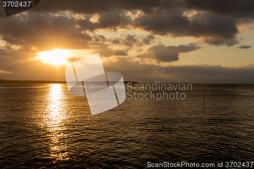 Image of Nusa penida, Bali beach with dramatic sky and sunset