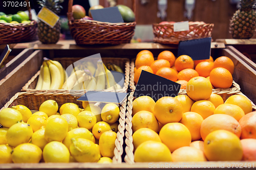 Image of fruits in baskets with nameplates at food market