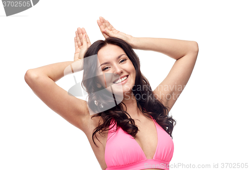 Image of happy young woman in pink bikini swimsuit