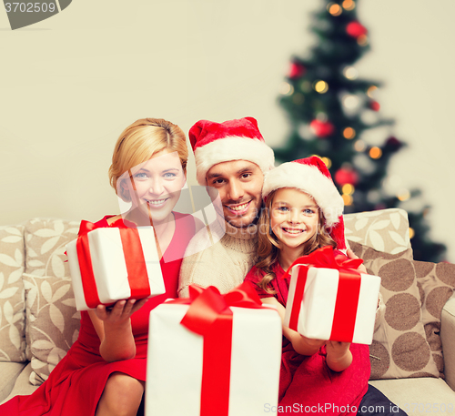 Image of smiling family giving many gift boxes