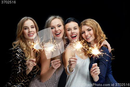 Image of happy young women dancing at night club disco