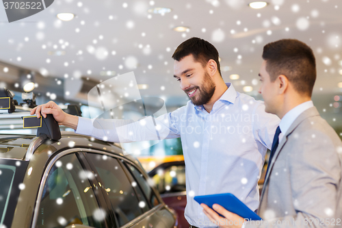 Image of happy man with car dealer in auto show or salon