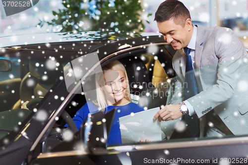 Image of happy woman with car dealer in auto show or salon