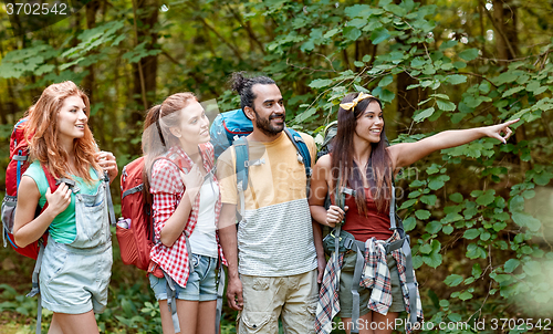 Image of group of smiling friends with backpacks hiking