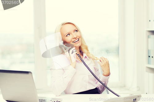 Image of smiling businesswoman or student calling on phone
