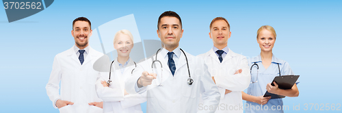 Image of group of doctors with clipboard pointing at you