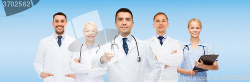 Image of group of doctors with clipboard pointing at you