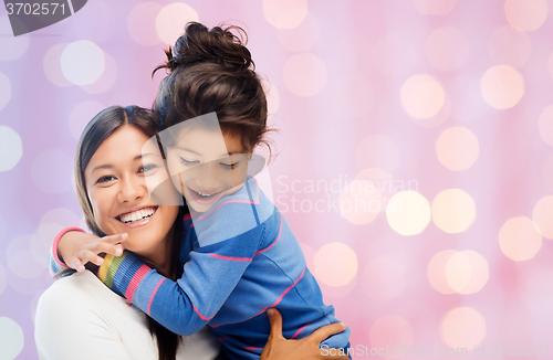 Image of happy mother and daughter hugging