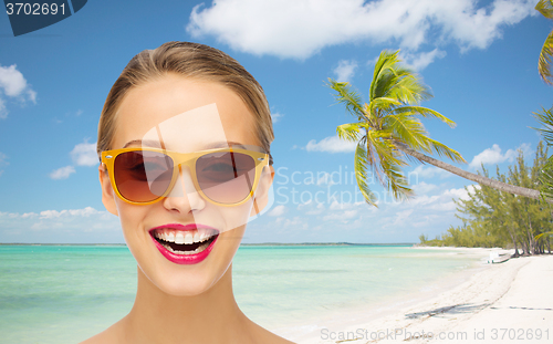 Image of happy young woman in sunglasses with pink lipstick