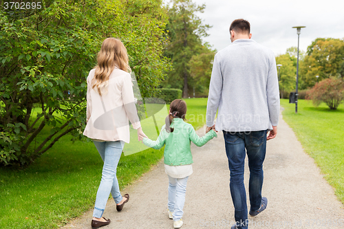 Image of happy family walking in summer park