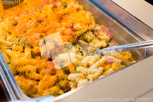 Image of close up of pasta and spoon on catering tray