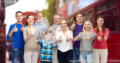 Image of group of people showing thumbs up over london city