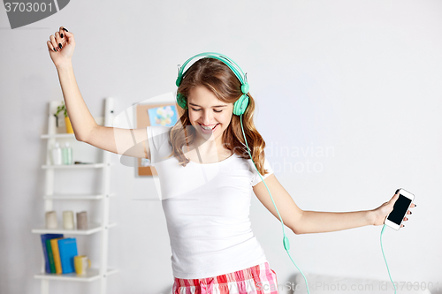 Image of happy woman in headphones ihaving fun at home