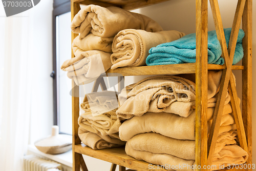 Image of close up of wooden rack with fleece plaids