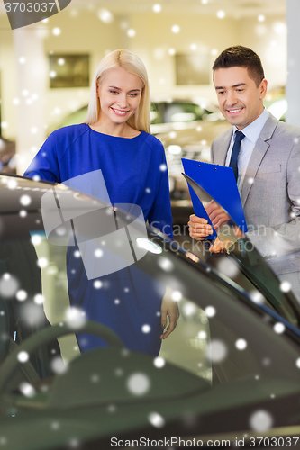 Image of happy woman with car dealer in auto show or salon