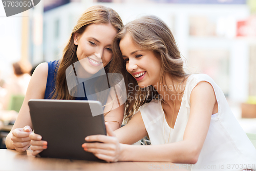 Image of happy young women or teenage girls with tablet pc