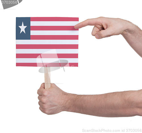 Image of Hand holding small card - Flag of Liberia