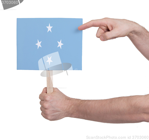 Image of Hand holding small card - Flag of Micronesia