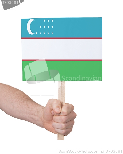 Image of Hand holding small card - Flag of Uzbekistan