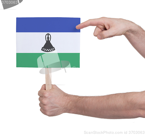 Image of Hand holding small card - Flag of Lesotho