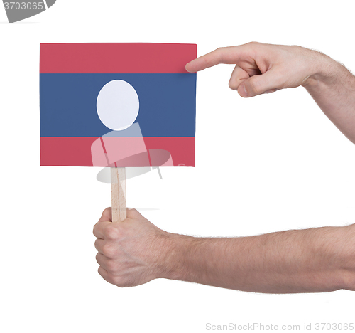 Image of Hand holding small card - Flag of Laos