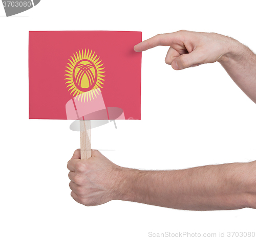 Image of Hand holding small card - Flag of Kyrgyzstan
