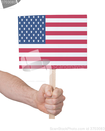 Image of Hand holding small card - Flag of the USA