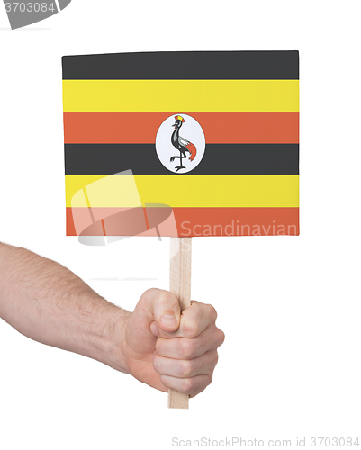 Image of Hand holding small card - Flag of Uganda