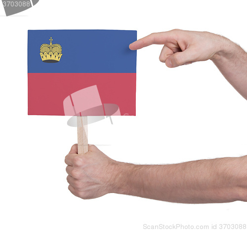 Image of Hand holding small card - Flag of Liechtenstein