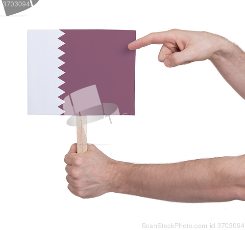 Image of Hand holding small card - Flag of Qatar
