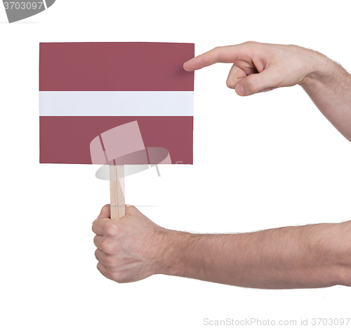 Image of Hand holding small card - Flag of Latvia