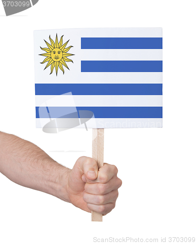 Image of Hand holding small card - Flag of Uruguay
