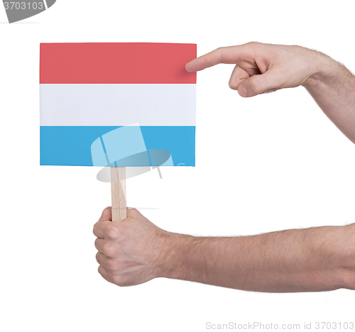 Image of Hand holding small card - Flag of Luxembourg