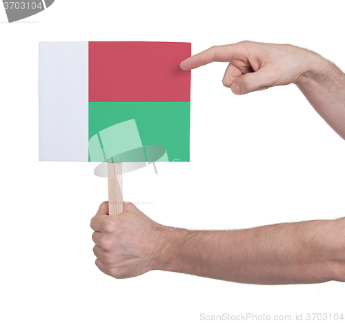 Image of Hand holding small card - Flag of Madagascar