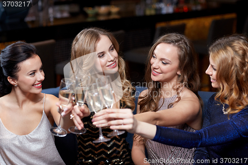 Image of happy women with champagne glasses at night club