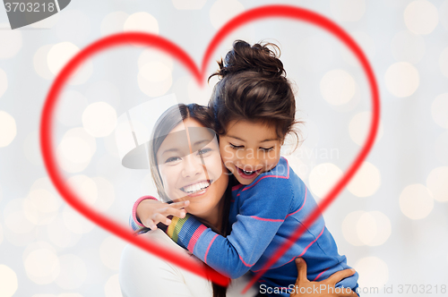 Image of happy mother and daughter hugging