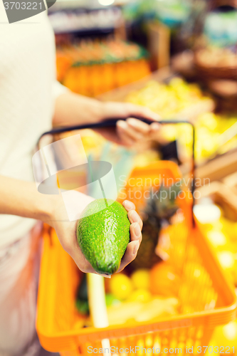 Image of close up of woman with food basket in market