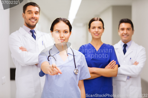 Image of group of medics pointing finger on you at hospital