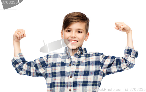 Image of happy boy in checkered shirt showing strong fists