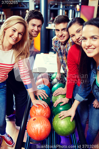 Image of happy friends in bowling club