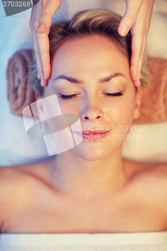 Image of close up of woman having face massage in spa