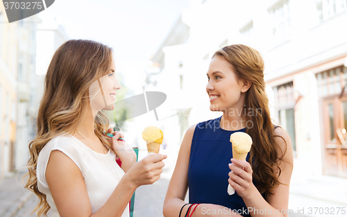 Image of woman with shopping bags and ice cream in city