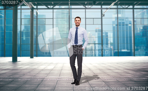 Image of handsome businessman over city construction