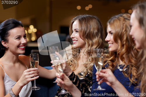 Image of happy women with champagne glasses at night club