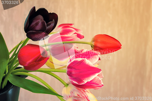 Image of Beautiful bouquet of tulips in a ceramic vase.