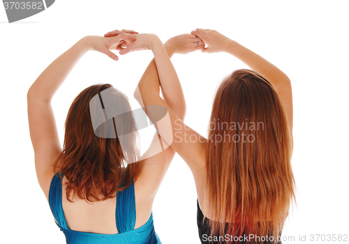 Image of Two girls with there hands up.