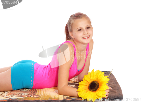 Image of Young girl lying in bathing suit on a towel.