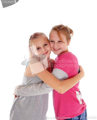 Image of Smiling sisters hugging each other.