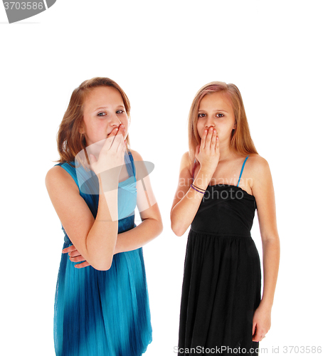 Image of Two girls with hands over there mouth.